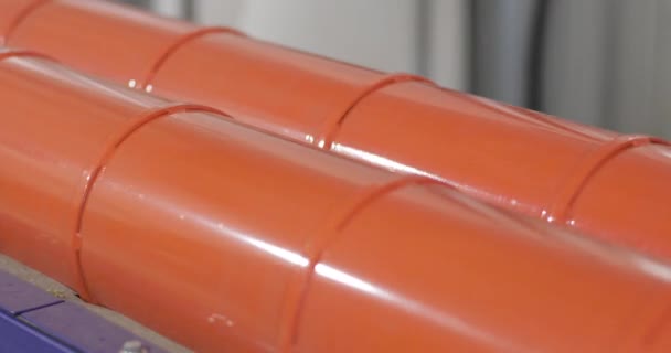 Two red pipes with insulation are spinning — Stock Video