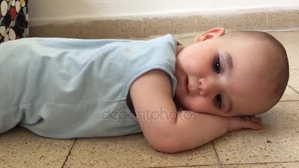 Shot of Smiling baby boy on the floor — Stock Video