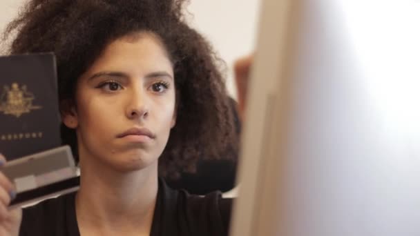 Schot van vrouw met paspoort gegevens te typen — Stockvideo