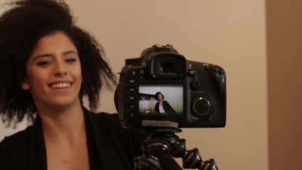 Shot of Smiling young female shooting self video — Stock Video