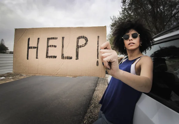 Woman traveling alone holding help sign — Stock Photo, Image