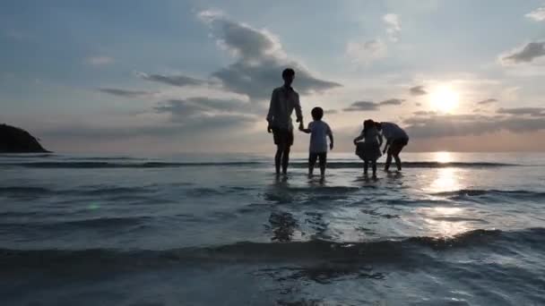 幸せなアジアの家族夏休みに父 娘はビーチで一緒に水の海をプレイします 海の背景日没 休日と旅行のコンセプトをリラックス スローモーション — ストック動画