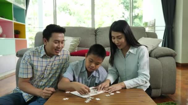 Asian Family Mother Father Son Play Jigsaw Puzzle Game Together — Stock Video