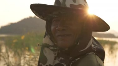 Balıkçıların yüzünü kapatın. Asyalı yaşlı adam akşam gülümsüyor