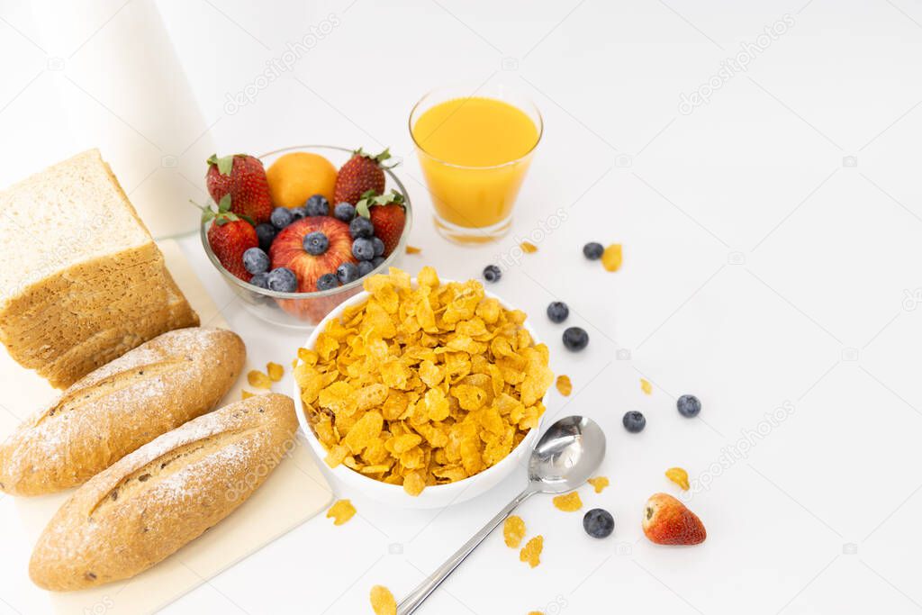 Healthy breakfast. bread, orange juice, strawberry, blueberries, milk and cereal in bowl on white background. Healthy food