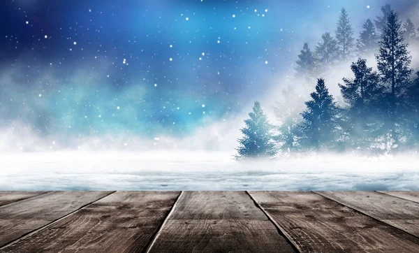 Dark winter forest background at night. Winter snow landscape with wooden table in front. Snow, fog, moonlight. Dark neon night background in the forest with moonlight. Neon figure in the center. Night view, magic.