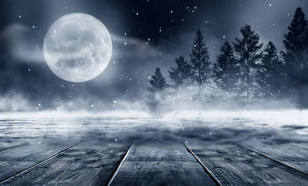 Dark winter forest background at night. Winter snow landscape with wooden table in front. Snow, fog, moonlight. Dark neon night background in the forest with moonlight. Neon figure in the center. Night view, magic.