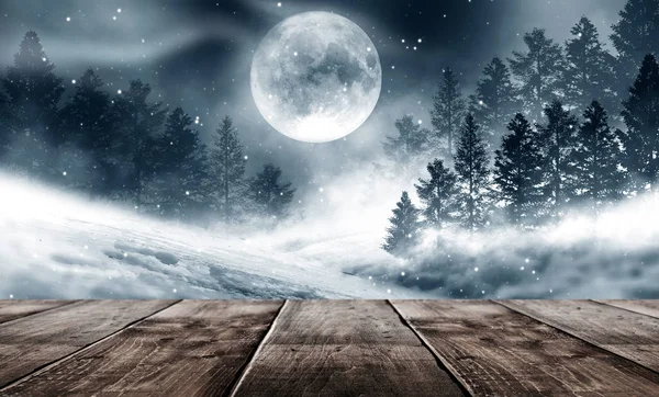 Dark winter forest background at night. Winter snow landscape with wooden table in front. Snow, fog, moonlight. Dark neon night background in the forest with moonlight. Neon figure in the center. Night view, magic.