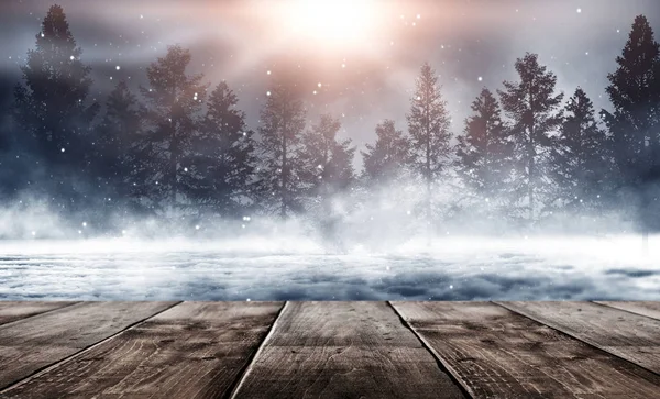 Dark winter forest background at night. Winter snow landscape with wooden table in front. Snow, fog, moonlight. Dark neon night background in the forest with moonlight. Neon figure in the center. Night view, magic.