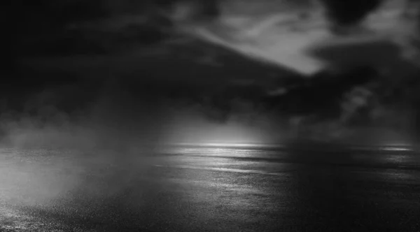 Dramatic black and white background. Cloudy night sky, moonlight, reflection on the pavement. Smoke and fog on a dark street at night. Night futuristic landscape, cold night.