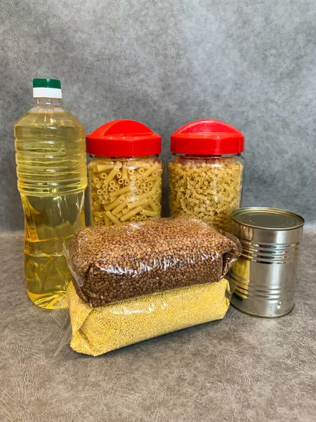 Crisis food products for isolation period. Macaroni, oil, canned food, vegetables, sugar, oatmeal, millet, lemons, ginger. Food Delivery, Donation, Coronavirus Quarantine.