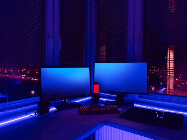 Neon ışıkları olan bir oda. Oyun Alanı. Bilgisayar oyunları, oyun sporları ve akış için iç mekan. İç kısımda soyut neon arkaplan. Odanın gece görüşü, beyaz masa, neon ışık. Mavi ve pembe neon.