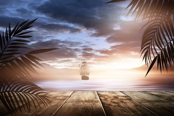 Sea evening landscape with sunset. Palm tree branches, silhouettes, sunlight. Wooden table by the sea. Night view, open-air seascape.