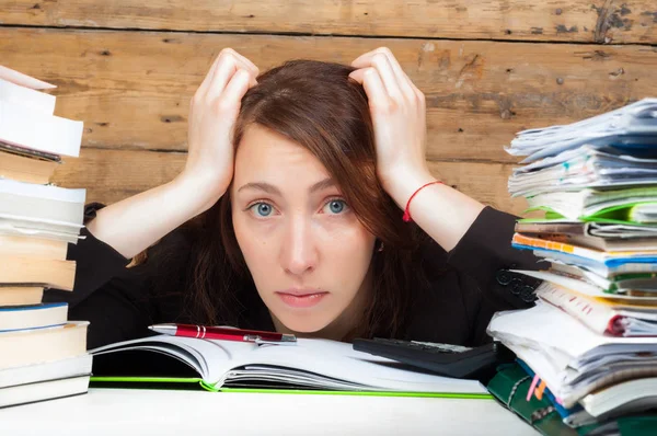 Woman got tired of working and studying next to the stack of pap Stock Image