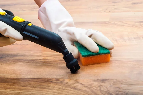 Wooden, parquet, laminate floors cleaning with steam in the room