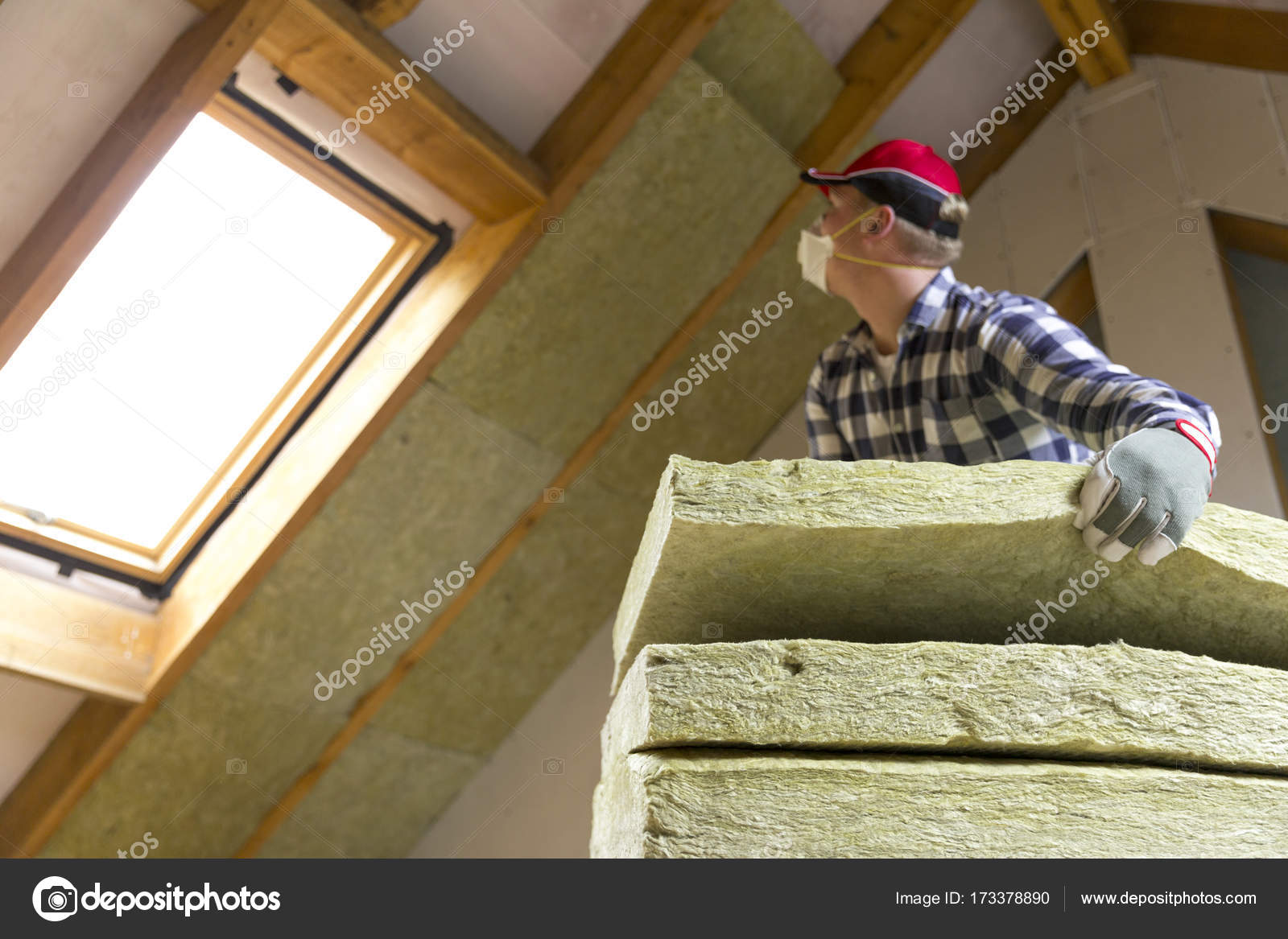 Man Installing Thermal Roof Insulation Layer Using Mineral