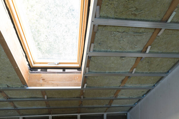 house attic under construction mansard wall insulation with rock