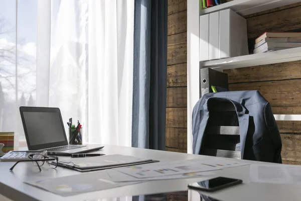 Empty workplace with office desk and chair, jacket on the chair, — Stock Photo, Image