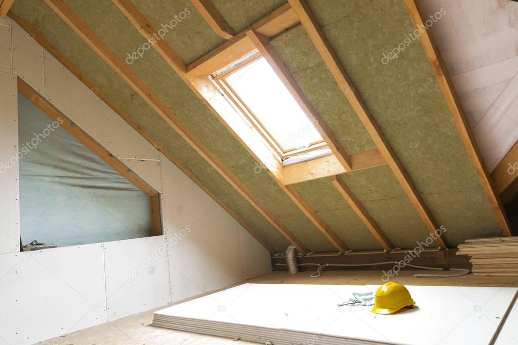 House attic under construction mansard wall insulation with rock