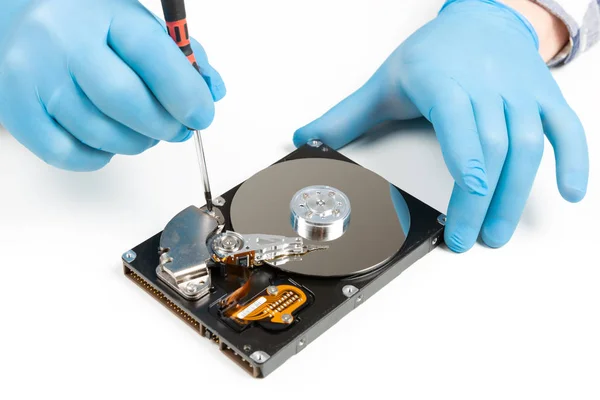 Men's hands in blue gloves repairing dismantled hard drive. Comp — Stock Photo, Image