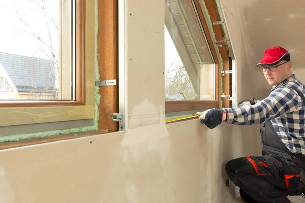 Handyman, construction man installing PVC window in a new insula — 스톡 사진