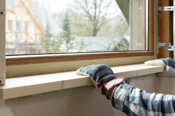 Home improvement handyman installing window sill in new build at — Stock Photo, Image