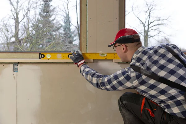 Home improvement handyman installing window sill in new build at — 스톡 사진