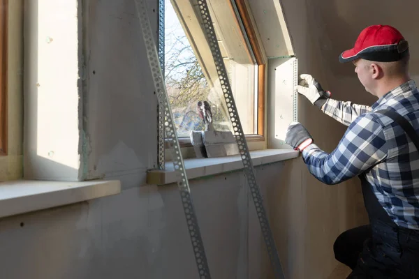 Home improvement handyman installing window in new build attic b — 스톡 사진