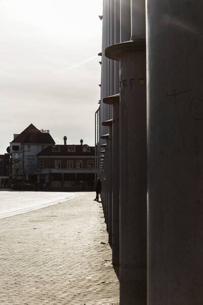 Man Leaning Against Building