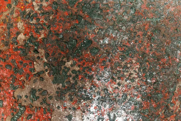 Red & Green Dried Paint Etched Into Concrete Surface