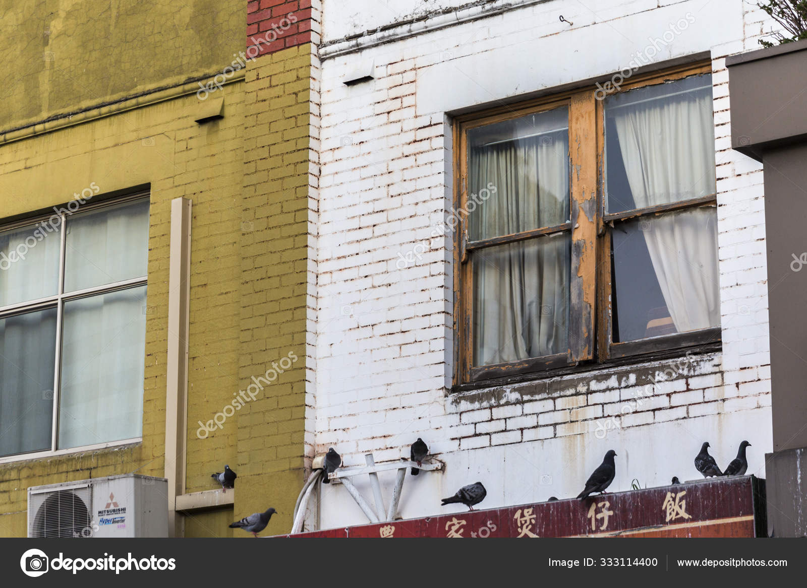 Pigeons Sitting Above Chinese Restaurant On Inner City Road Stock Photo