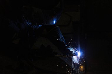 Kaynak makinesinden çıkan mavi kıvılcım parlıyor