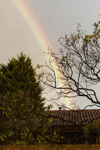 Rainbow Cast Over Suburban House