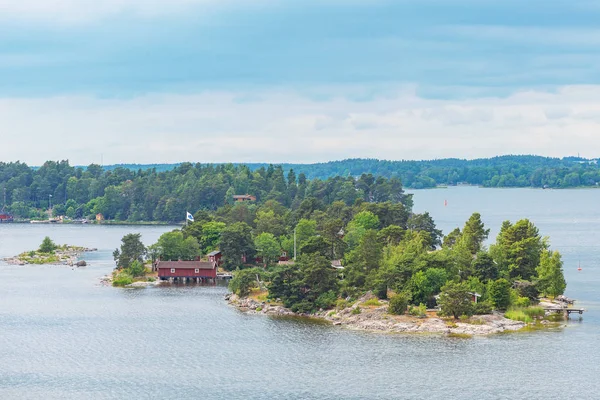 Klein eiland bedekt met sparren in het Zweedse scherenkust o — Stockfoto