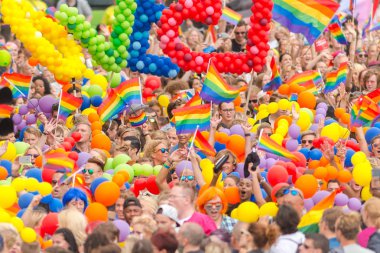 The colorful pride parade in Stockholm with happy people and wav clipart