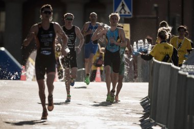 Arka ışık su istasyonu üzerinden çalışan triatlon koşucu