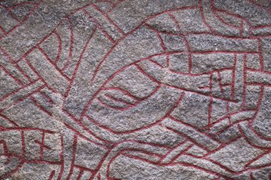 STOCKHOLM, SWEDEN, APRIL, 1, 2018: Detail of viking Rune Stone in Gamla Stan, Stockholm Old Town in the corner Prastgatan and Kakbringen. clipart