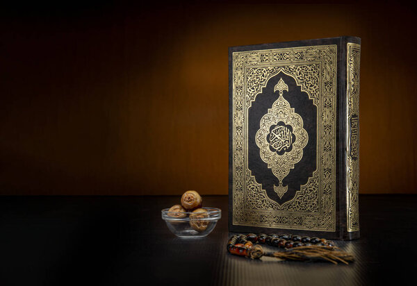 Holy Book of Quran With Rosary and Dates on Black Background, Celebrating Holy Month of Ramadan