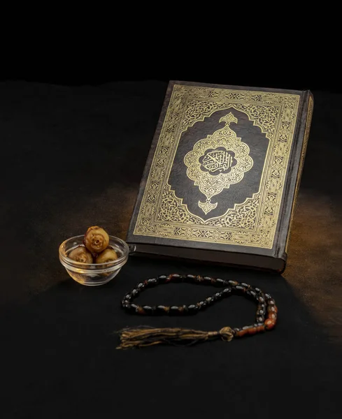 Holy Book of Quran With Rosary and Dates on Black Background, Celebrating Holy Month of Ramadan