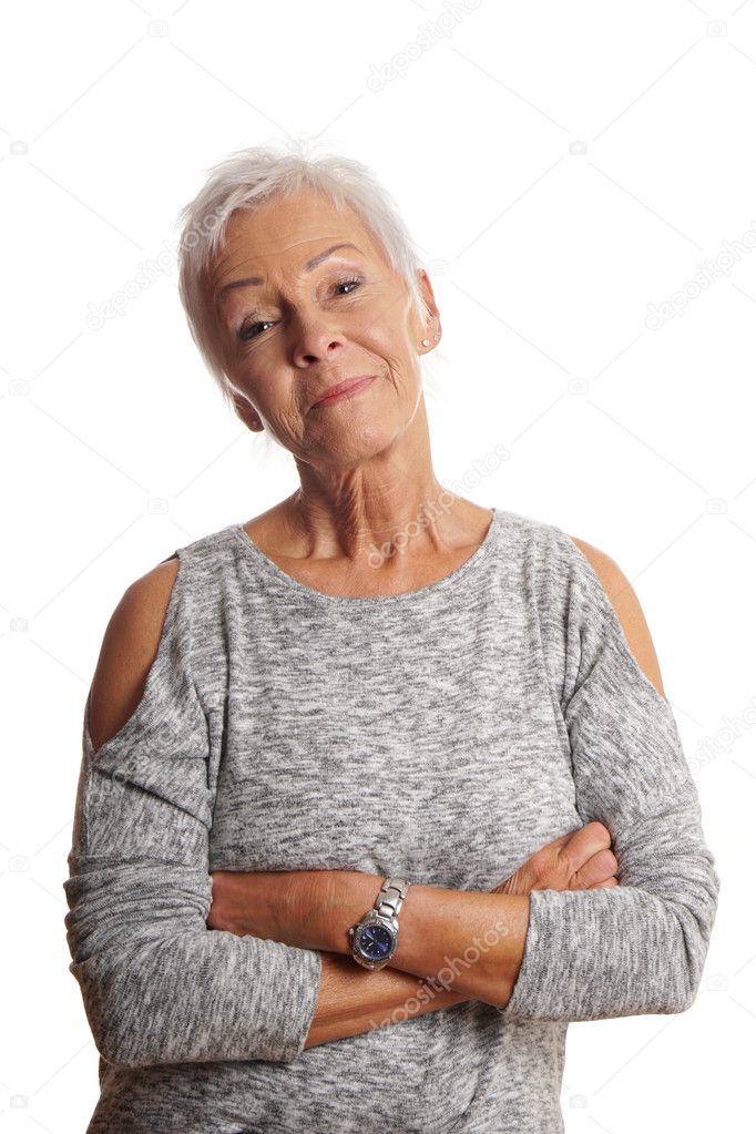 mature woman with arms folded and head tilted
