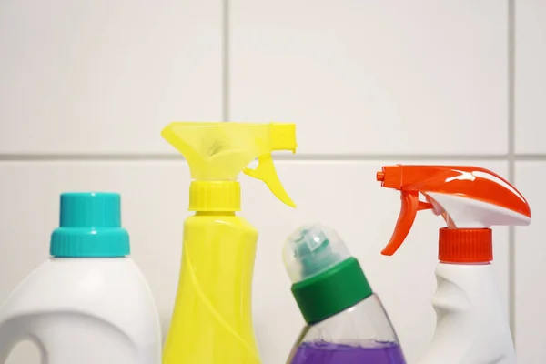 Cleaning products in front of bathroom tiles — Stock Photo, Image