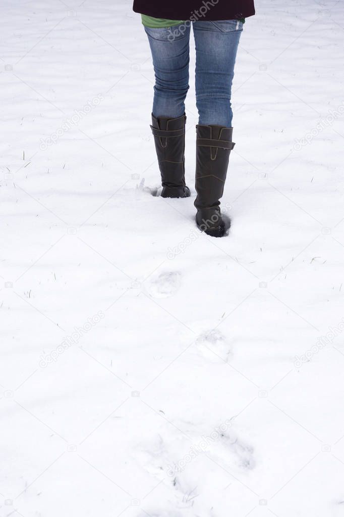 woman walking through snow