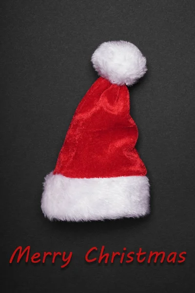 Santa claus hat with merry christmas greeting — Stock Photo, Image
