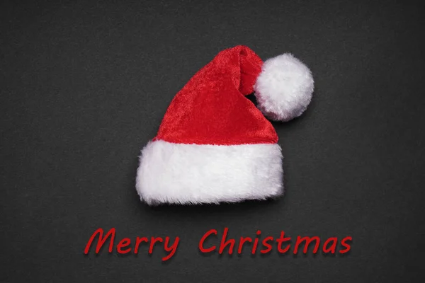 Santa claus hat with merry christmas greeting — Stock Photo, Image