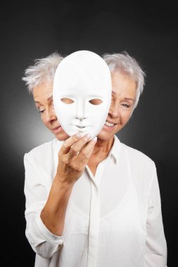 older woman hiding happy and sad face behind mask clipart