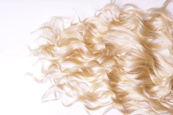 Curly blond hair on white background Stock Picture