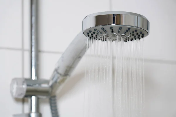 Shower with modern showerhead and running water in bathroom — Stock Photo, Image