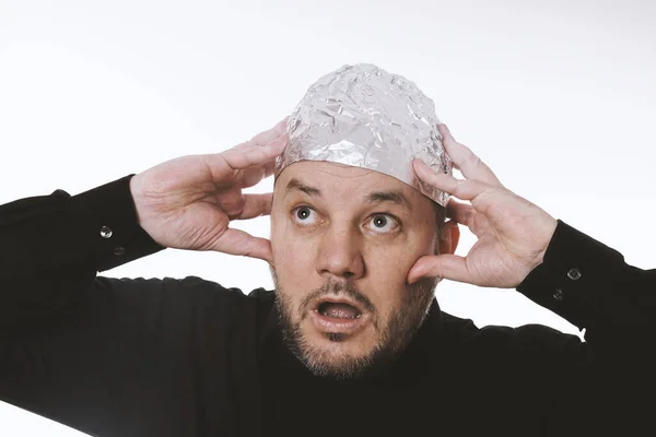 Paranoid man wearing tin foil hat — Stock Photo, Image