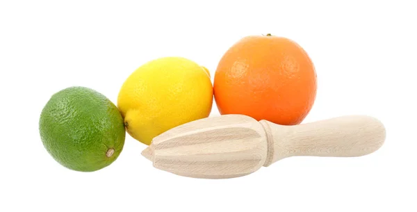 Lime, lemon and orange fruit with wooden citrus reamer — Stock Photo, Image