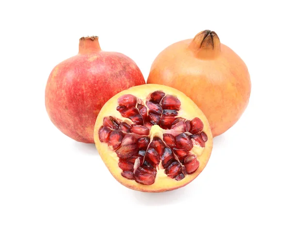Two pomegranates and a cut half showing seeds — Stock Photo, Image